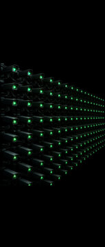 Vertical photo of a massive array of security cameras with glowing green lenses. Mass surveillance and omnipresent monitoring concept. Endless rows of cctv equipment on black background