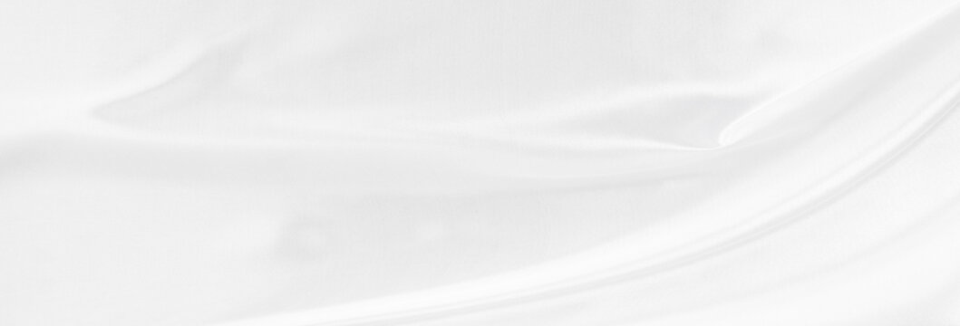 White gray satin texture that is white silver fabric silk panorama background with beautiful soft blur pattern natural.