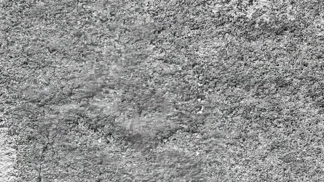 Seamless rotating loop of textured grey concrete ground surface, featuring weathered asphalt road patterns, industrial stone details, and solid raw cement backgrounds.