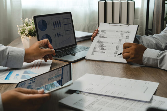 Business team consulting during a finance meeting, reviewing financial reports and dashboard data for budget planning, partnership strategy and collaborative business decision making.