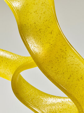 Abstract twisted lemon-yellow paste texture close-up, digital citrus cream swirl
