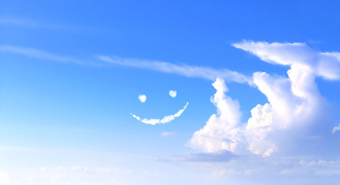 Positive lifestyle concept. Feeling happy and good mood concept. Funny cloud emoji on blue sky. Conceptual joy, freedom and summer vibes. Positive thinking. Inspiring emotional state and happiness