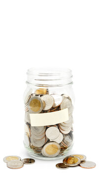 Glass jar full of Thai baht coins. Business and finance concept. Vertical Photography.