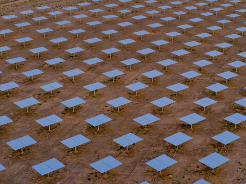 Molten salt tower solar thermal power plant at sunrise, new energy source, super mirror power plant, prism tower