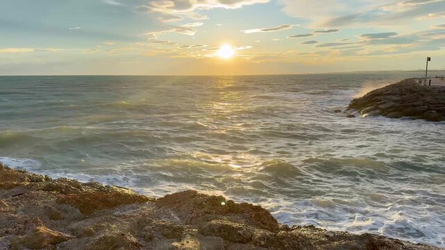 Waves Crashing on Rocky Coastline at Sunset 