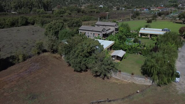 Rural Home With Surrounding Greenery. Peaceful Farming Estate Enveloped By Lush Vegetation And Open Land