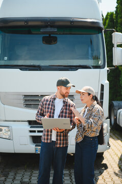 Truck drivers planning delivery route using laptop