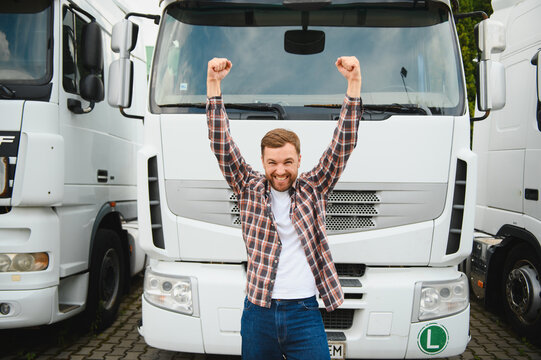 Happy truck driver celebrating success with arms raised