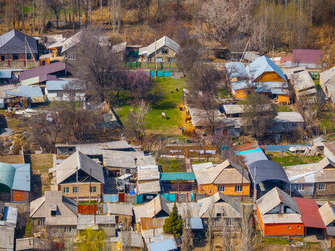 Aerial View of Rural Village with Houses and Livestock in Kyrgyzstan