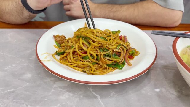 Chinese Restaurant Table with Noodles on Plate and Wonton Soup in Bowl &ndash; Traditional Dumplings and Noodle Dish