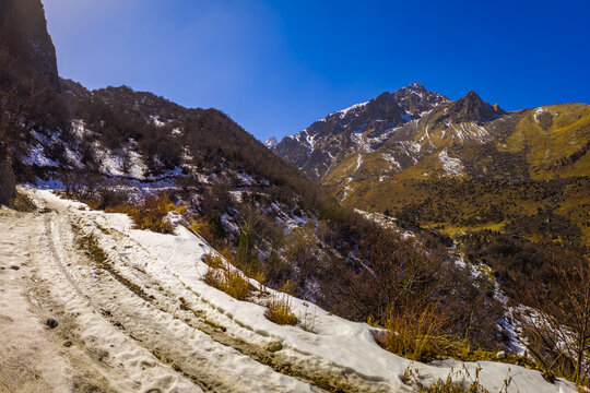 Snowy Mountain Road Winding Through Rugged Terrain in Kyrgyzstan