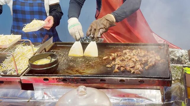 Korean Street Food &ndash; Grilling Skewers and Beef Steak Over Open Flame at Outdoor Market Stall