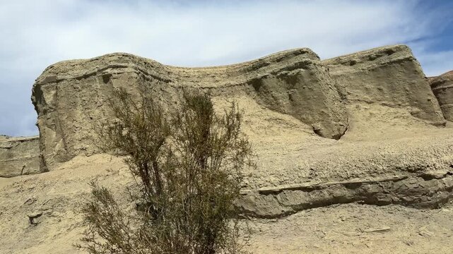 Majestic Yardang landform of Urho Ghost City under a dramatic cloudy sky in Karamay, Xinjiang, China.