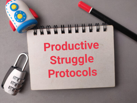 A notepad reading Productive Struggle Protocols sits framed by a toy rocket, padlock, and pencil on gray
