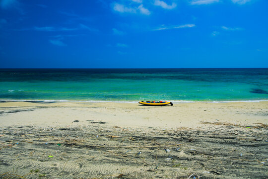 Kayak on the sandy shore of a beautiful blue sea near the wetland and state nature reserve of Le Cesine, province of Lecce, Puglia region, Italy.  