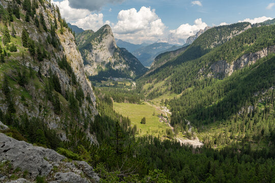 Rocca Pietore, Italy. Panoramic alpine valley with forests, mountain cliffs and hiking trails in the Dolomites