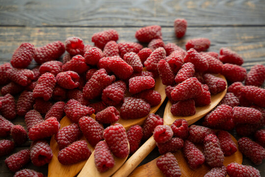  organic raspberries on wooden table background, food blogging, healthy eating concepts, and seasonal summer harvest themes. Small Farm food	