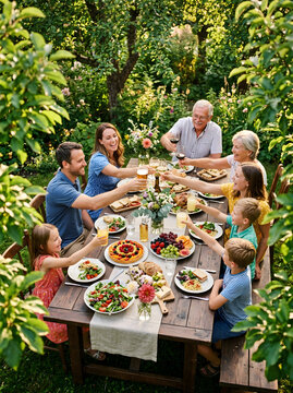 Joyful Family Gathering Outdoors Enjoying Summer Garden Feast