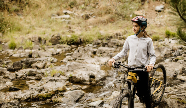 Mountain biking adventure by a serene stream in the wilderness