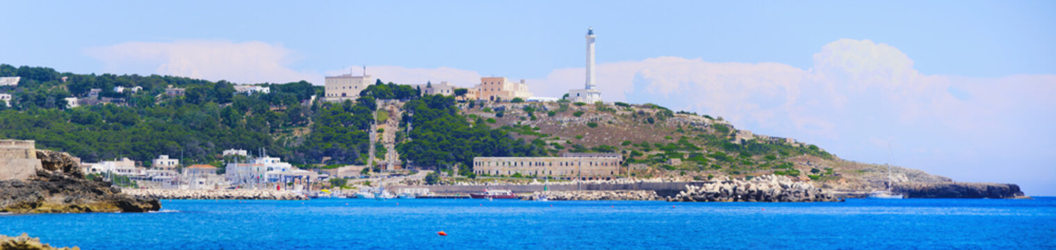 Wide format photography of the promontory of Leuca with the ionic lighthouse, the historical sanctuary Santa Maria di Leuca and the monumental staircase. Gagliano del Capo, Apulia, Italy