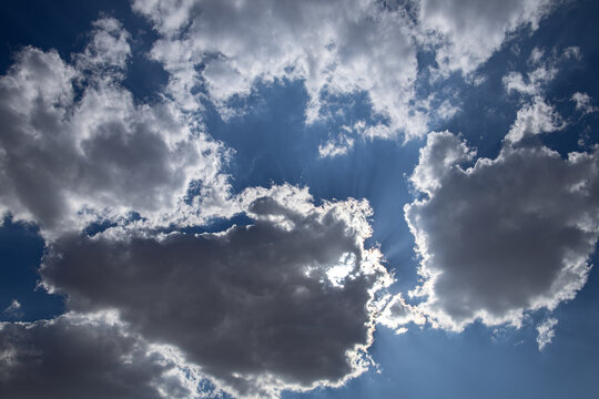 Dramatic cloudy sky with sun rays breaking through