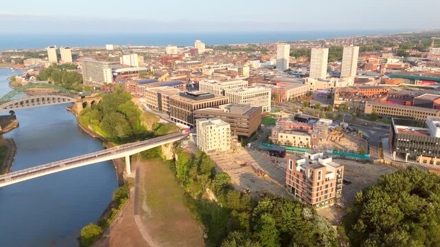 Sunderland UK: 17th July 2026: Panning drone footage of Sunderland River wear and city centre at golden hour. Keel Crossing footbridge, Wearmouth Bridge and the Monkwearmouth Railway Bridge at sunset