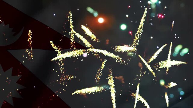 Bright golden fireworks exploding in the night sky behind the national flag of Nepal