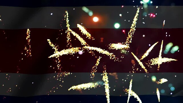 Bright golden fireworks exploding in the night sky over the flag of Costa Rica