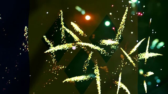 Bright golden fireworks exploding in the night sky over the flag of Saint Vincent and the Grenadines