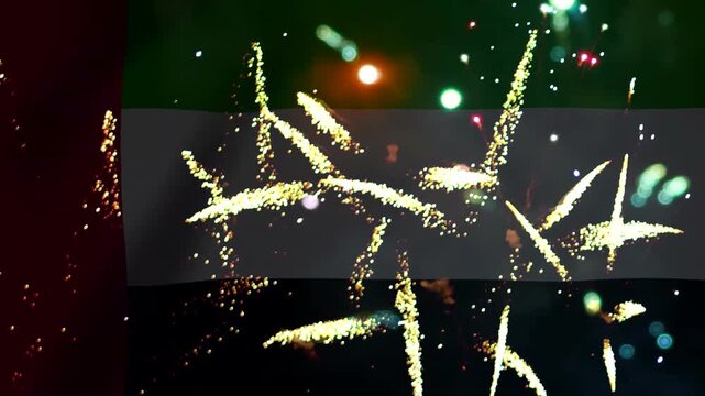 Bright golden fireworks exploding in the night sky over the flag of the United Arab Emirates during a national celebration