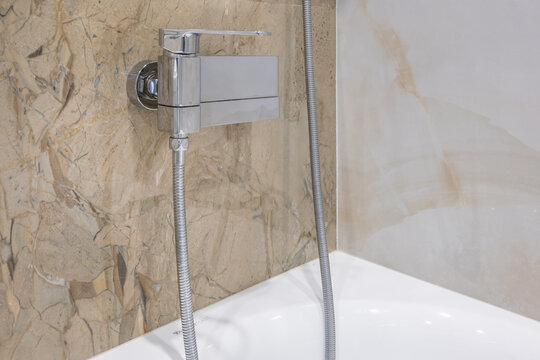  details of corner with water tap sink with faucet with soap and shampoo dispensers in expensive bathroom in rustic eco style