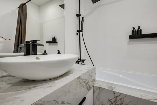  details of corner with water tap sink with faucet with soap and shampoo dispensers in expensive bathroom in rustic eco style