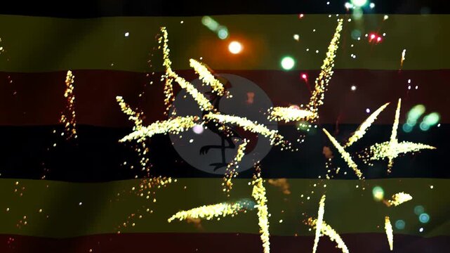 Bright golden fireworks exploding over the national flag of uganda celebrating independence day