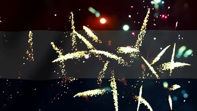 Bright golden fireworks exploding over the national flag of yemen during a night celebration