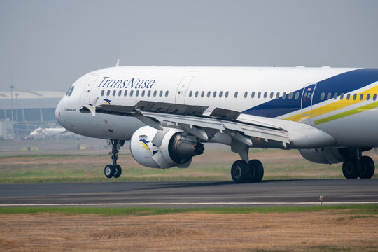 Jakarta, Indonesia - August 22, 2026: TransNusa Airbus A320 lands at Soekarno-Hatta International Airport with extended flaps, deployed spoilers, and thrust reversers.