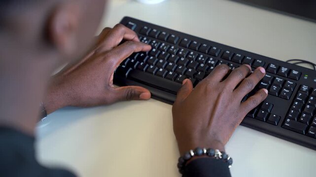 Man typing on a keyboard in an office