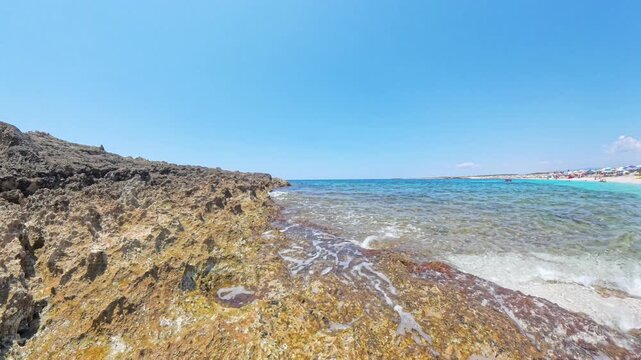Scenic view of dark volcanic rocks and turquoise sea at Is Arutas beach Sardinia Italy with quartz sand in distance
