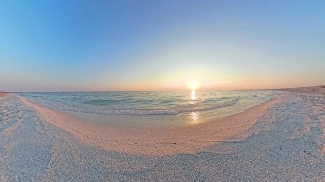 Static POV warm red sunset with vivid orange reflections on wet sand at Mari Ermi Sardinia