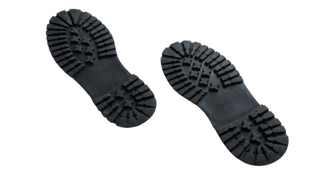 Pair of black boot sole footprints showing rugged tread pattern