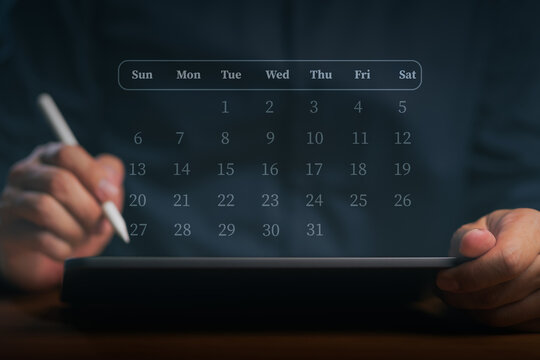 Businessman using tablet and digital calendar for time management. Man holding stylus planning business schedule with modern technology. Organization and futuristic scheduling concept.
