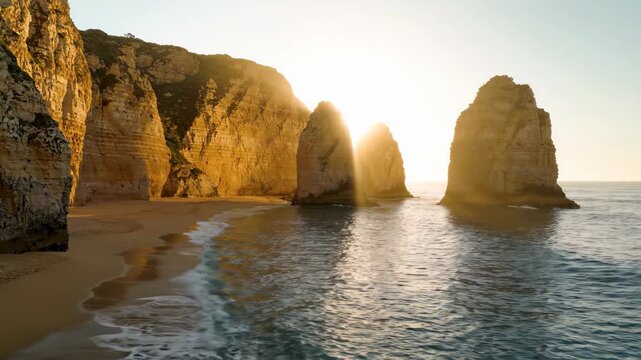 Golden sunset light over ocean sea stacks and rocky cliffs at the coast
