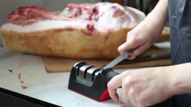Hands-on Pork Preparation: Trimming Bone-In Pork on Cutting Board in Home Kitchen