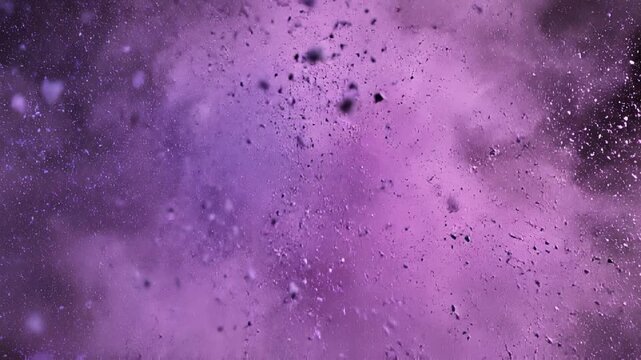 Purple powder explosion and scattering against a dark background with subtle motion effects