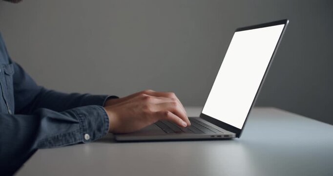 Business professional typing on laptop with white screen for office data