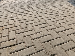 Herringbone Pattern Concrete Paver Blocks for Outdoor Pavement and Driveway Background © Sambada