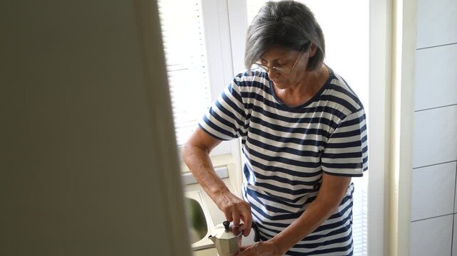 Older Woman Preparing Espresso at Home