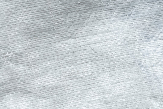 White Plastic Woven Sack Texture Background,Macro,Close-up texture of a white plastic woven sack, polypropylene woven bag fabric pattern, suitable for industrial, packaging, and background design.