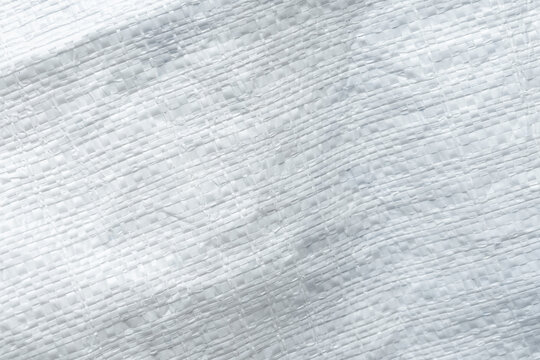 White Plastic Woven Sack Texture Background,Macro,Close-up texture of a white plastic woven sack, polypropylene woven bag fabric pattern, suitable for industrial, packaging, and background design.