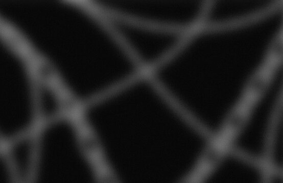 Abstract geometric shadow pattern on dark surface