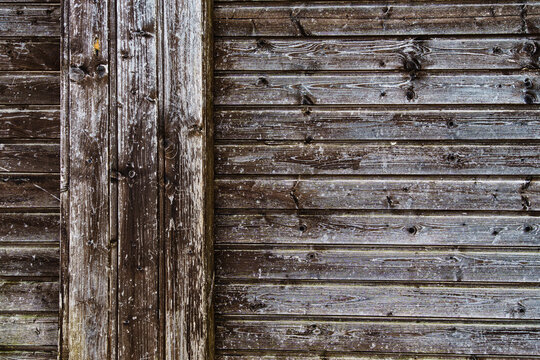 background of old weathered and cracked boards with peeling paint of brown color